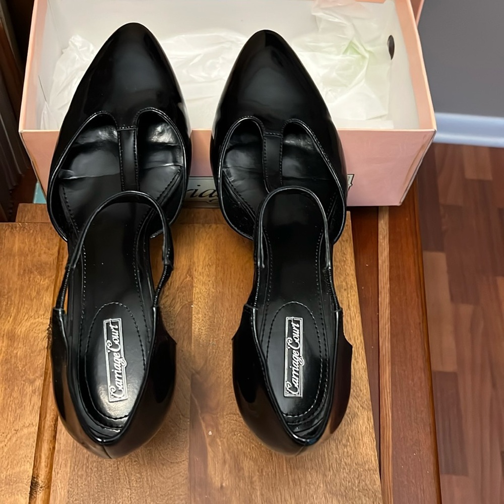 Black dress heels. Size 9 medium.Patent leather. Flexible t-strap across top.